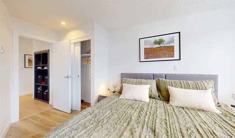 Bedroom with light wood-style flooring, a closet, and recessed lighting