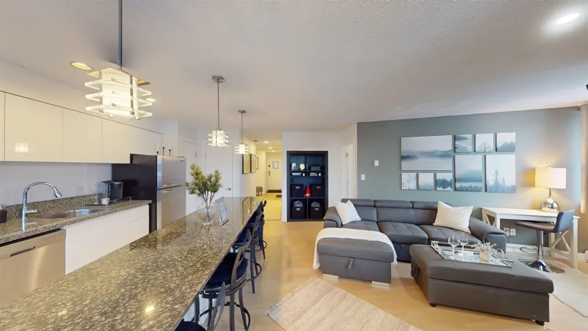 Living room featuring light wood finished floors, recessed lighting, and a textured ceiling