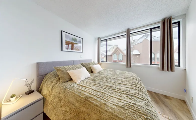 Bedroom featuring a textured ceiling and light wood-style floors
