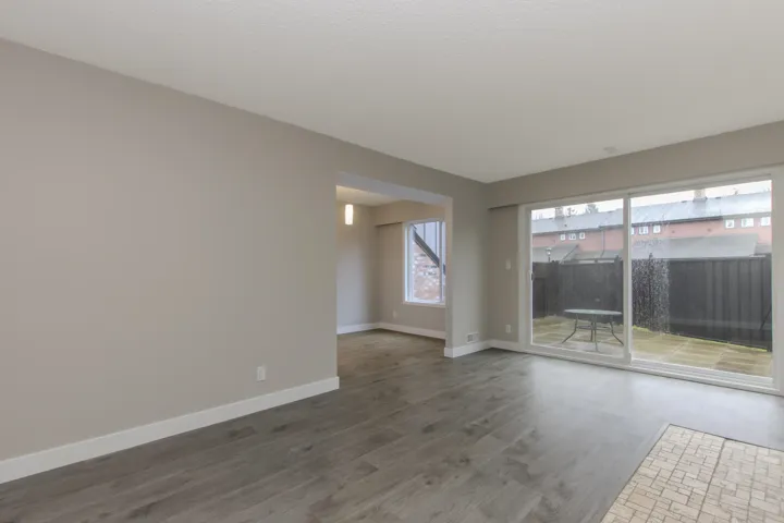Spare room with baseboards and wood finished floors