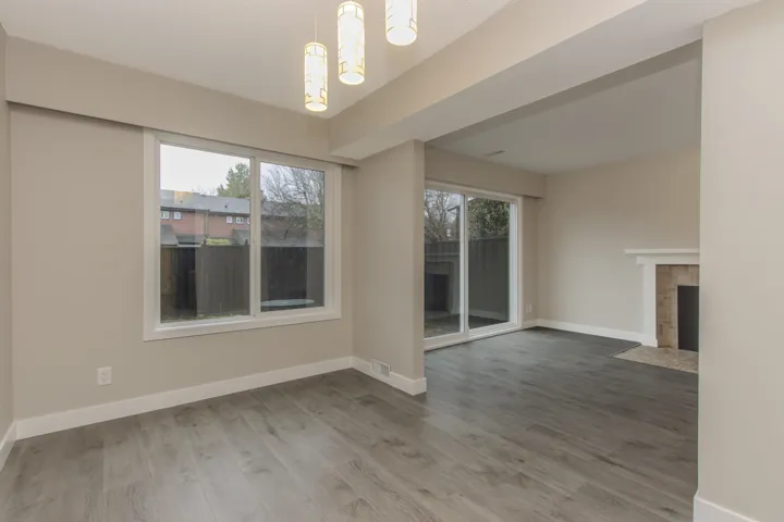 Unfurnished living room with plenty of natural light, light wood-style floors, and a tiled fireplace