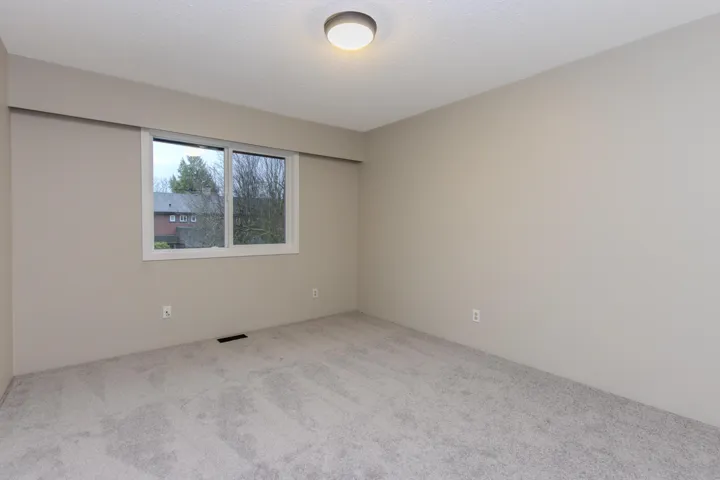 Unfurnished room with carpet flooring and a textured ceiling