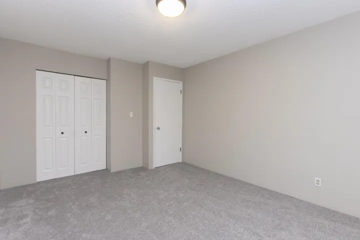 Unfurnished bedroom with a closet, carpet flooring, and a textured ceiling