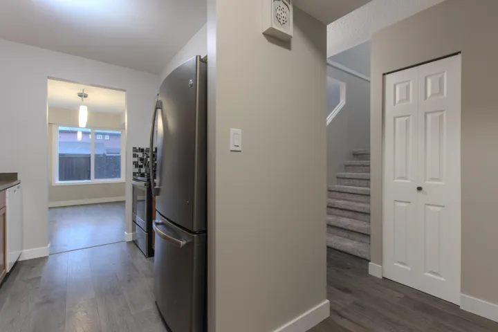 Hall featuring dark wood finished floors and stairway