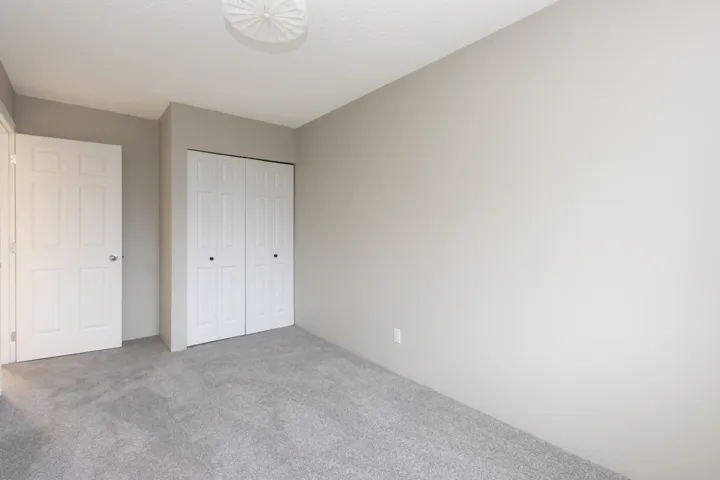 Unfurnished bedroom with a closet and carpet floors