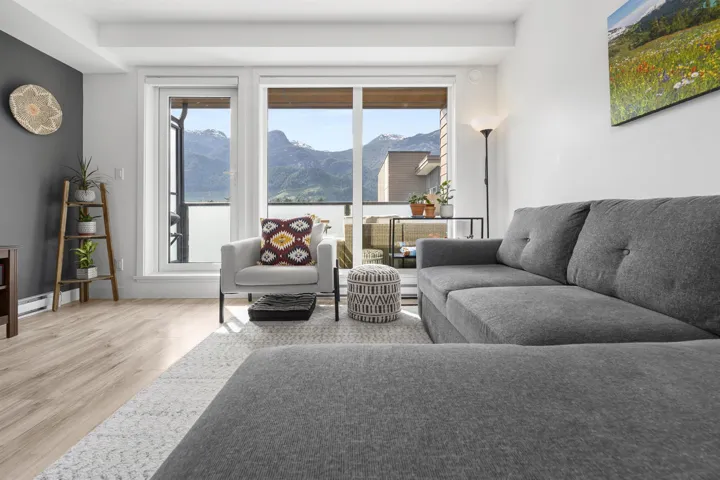 Living room featuring a mountain view, light wood finished floors, and plenty of natural light