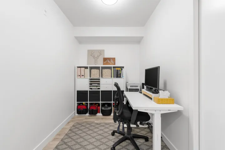 Home office featuring light wood-type flooring and baseboards