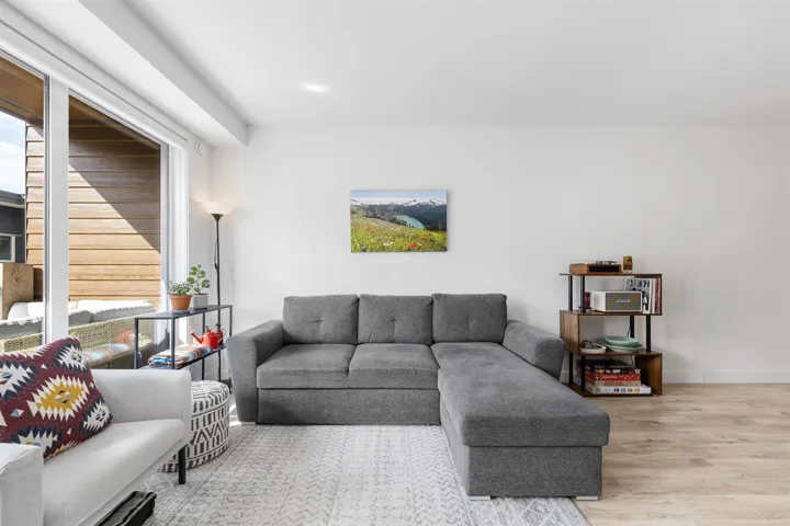 Living room with light wood-style flooring and baseboards