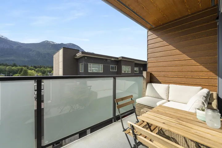 Balcony featuring a mountain view and an outdoor living space