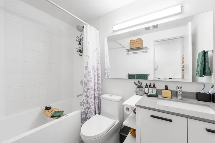 Bathroom with shower / tub combo and vanity