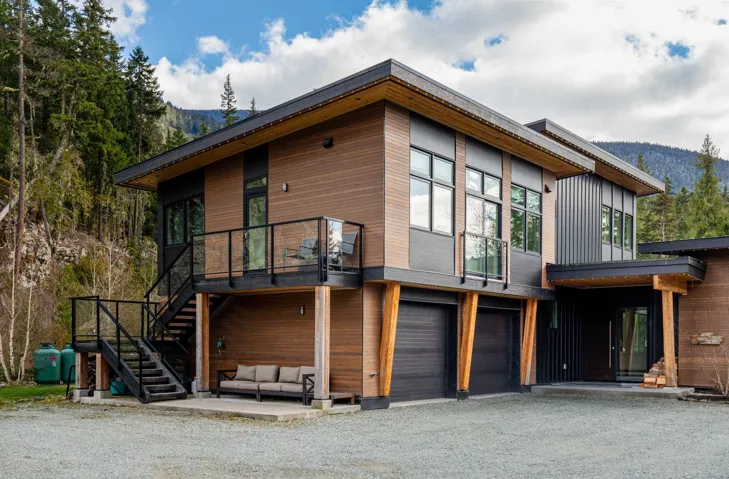 Modern architectural residence featuring multiple materials including wood-look siding and dark paneling