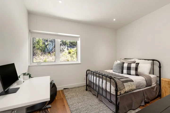 Bright room with a large window, recessed lighting, and wood-finish flooring