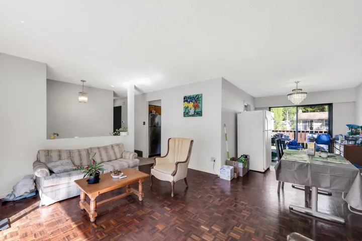 Open-concept living space featuring wood-finish parquet flooring throughout