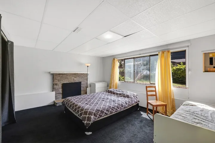 Room featuring dark carpet flooring and white walls