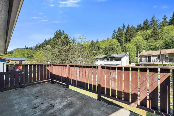 Outdoor deck with a concrete surface and a wooden railing