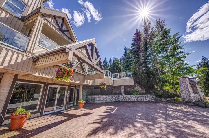 Rustic-modern exterior architecture featuring a prominent gabled entrance with exposed timber framing