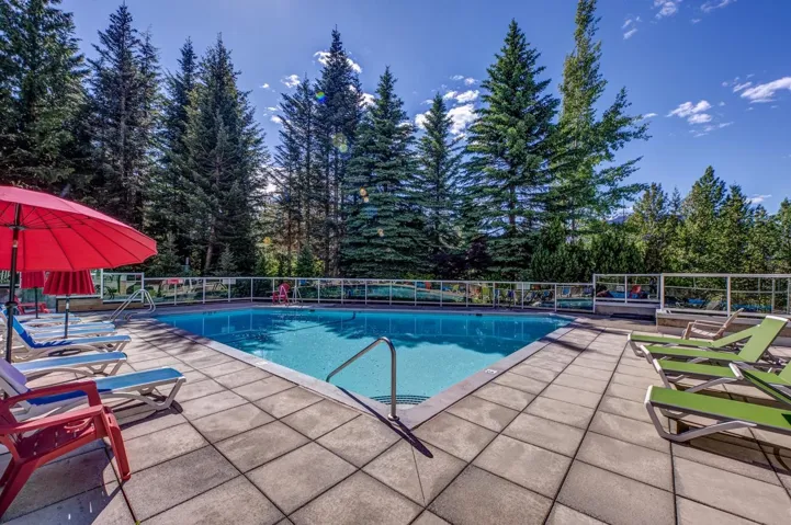 Outdoor swimming pool surrounded by a large paver patio