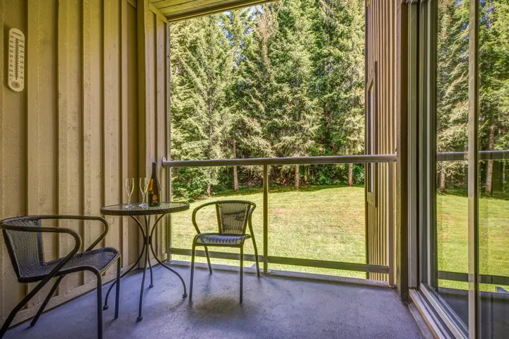 Private balcony featuring sliding glass door access, metal railing, and concrete flooring