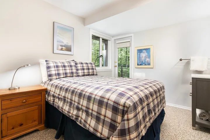 Bedroom featuring access to exterior and light carpet