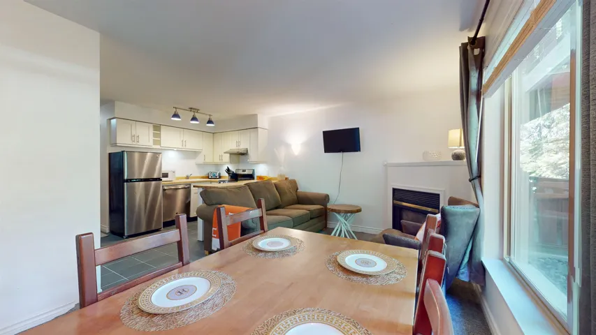 Dining room with a glass covered fireplace and track lighting