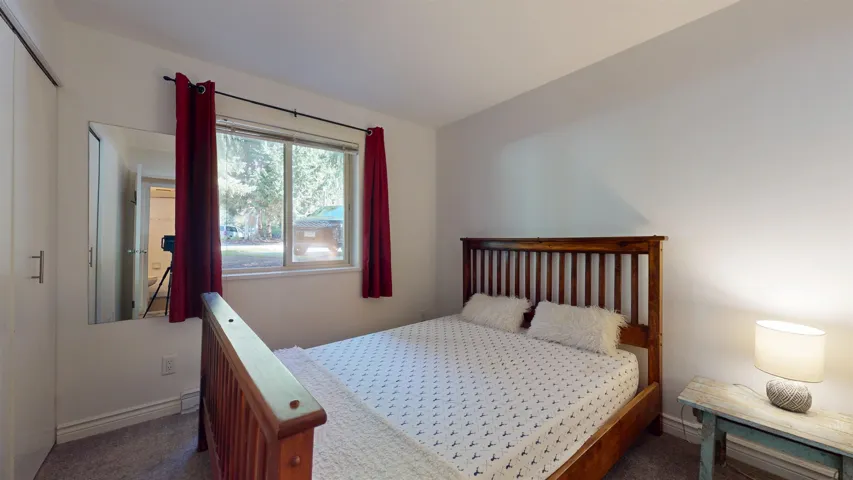 Bedroom featuring dark carpet