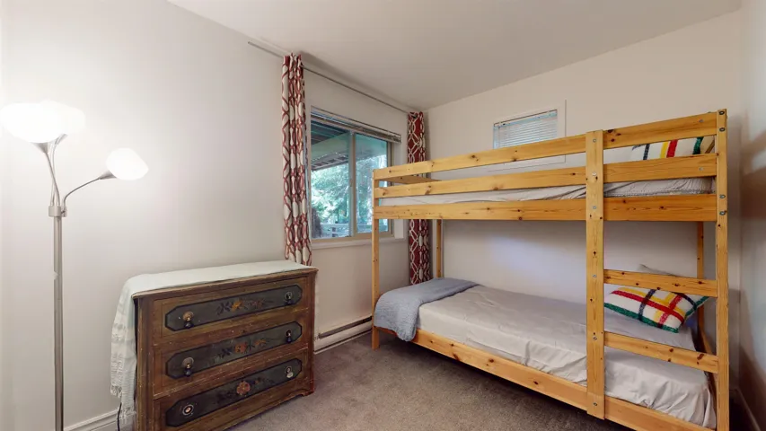 Carpeted bedroom with baseboard heating