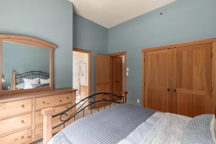 Bedroom featuring light blue walls and wood-finish trim