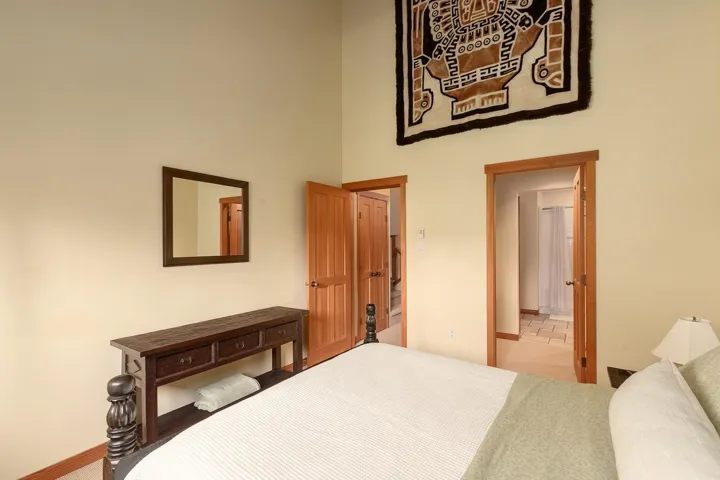 Bedroom featuring a vaulted ceiling and light-toned walls