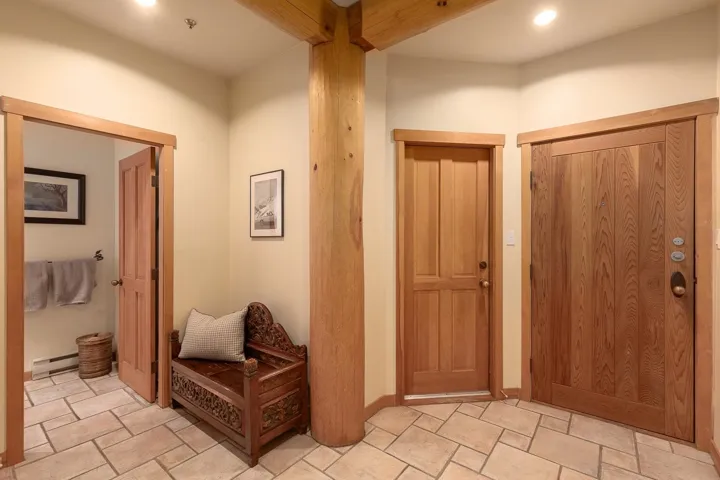Natural wood panel doors and trim, complemented by a large exposed wood structural post