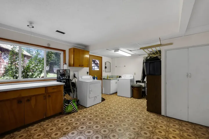 Laundry room featuring washer and clothes dryer, light flooring, and cabinet space