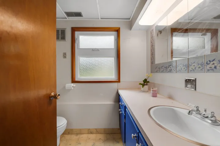 Bathroom with vanity and light floors