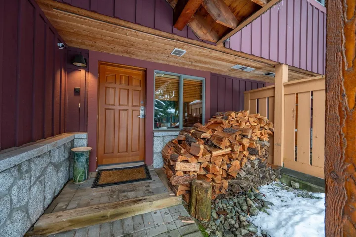 Property entrance featuring board and batten siding and a porch