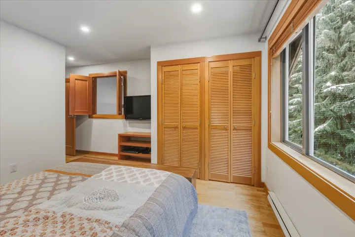 Bedroom featuring baseboard heating, light wood-style floors, and recessed lighting