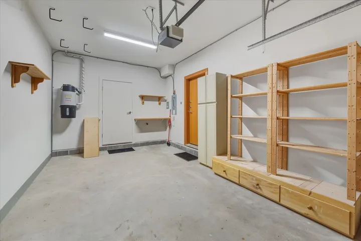 Garage with a garage door opener and electric panel