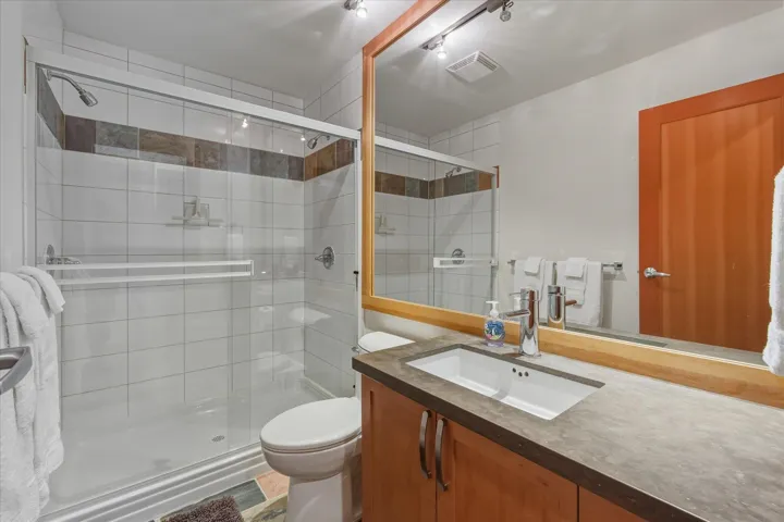 Bathroom featuring vanity and a stall shower