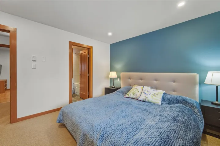Bedroom with carpet flooring, connected bathroom, and recessed lighting