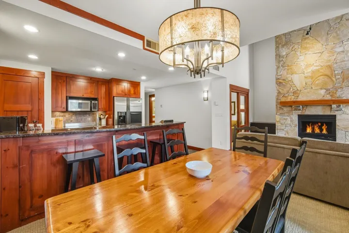 Dining space featuring a fireplace, a chandelier, and recessed lighting