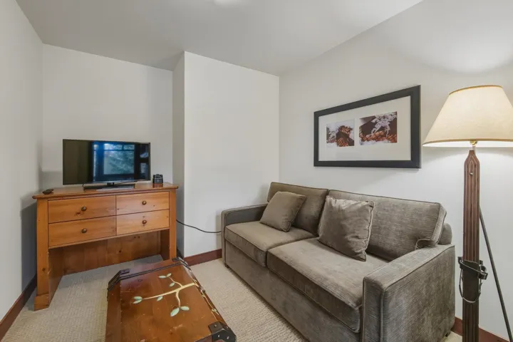 Carpeted living room featuring baseboards