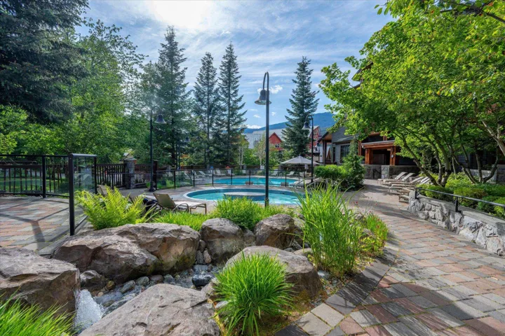 Community pool with a patio area and a gazebo