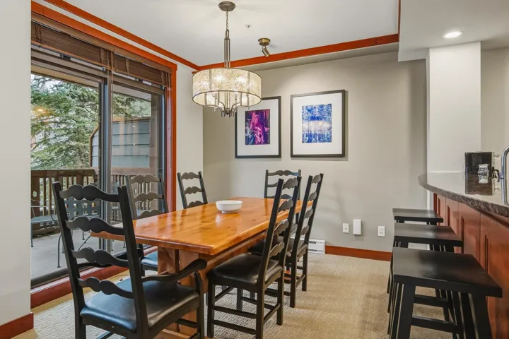 Dining space with baseboards and a chandelier