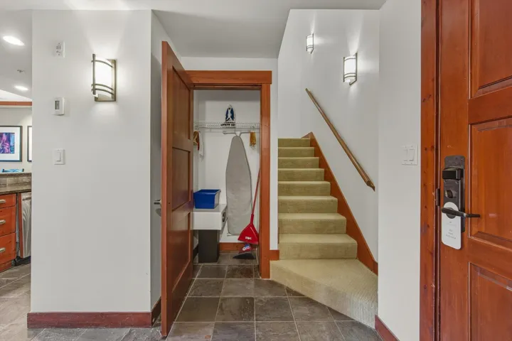 Stairs featuring stone finish flooring and recessed lighting