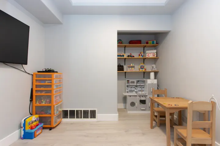 Living area featuring wood finished floors and a tiled fireplace