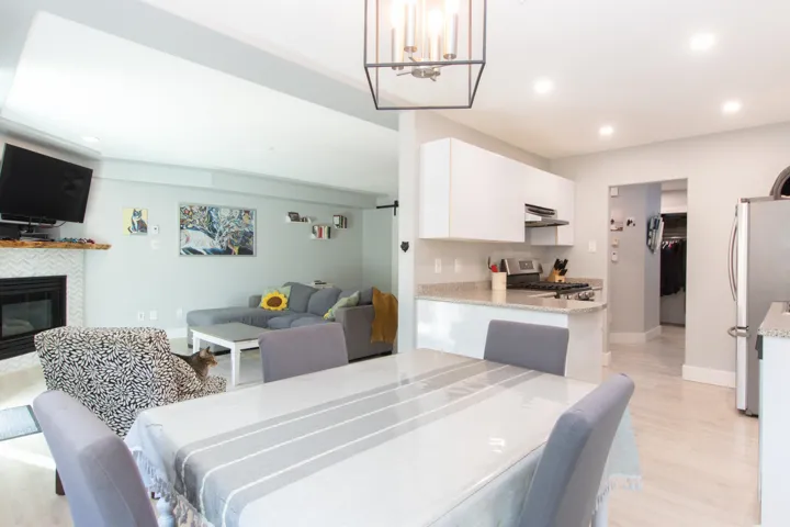 Dining space featuring recessed lighting, light wood-style flooring, and a tiled fireplace