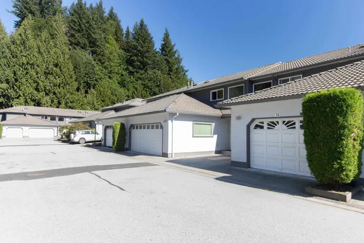 View of front facade featuring a tile roof and stucco siding