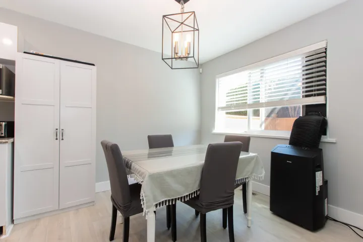 Dining space with light wood-style flooring and a chandelier