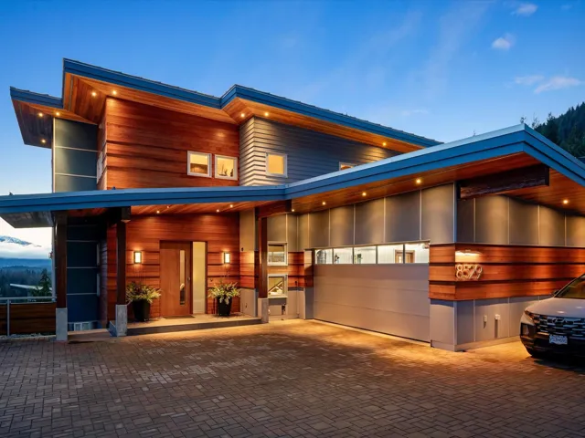 Contemporary house featuring decorative driveway and an attached garage