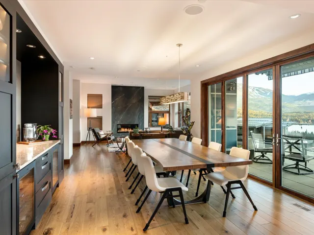 Dining room featuring a premium fireplace, light wood finished floors, beverage cooler, a mountain view, and recessed lighting
