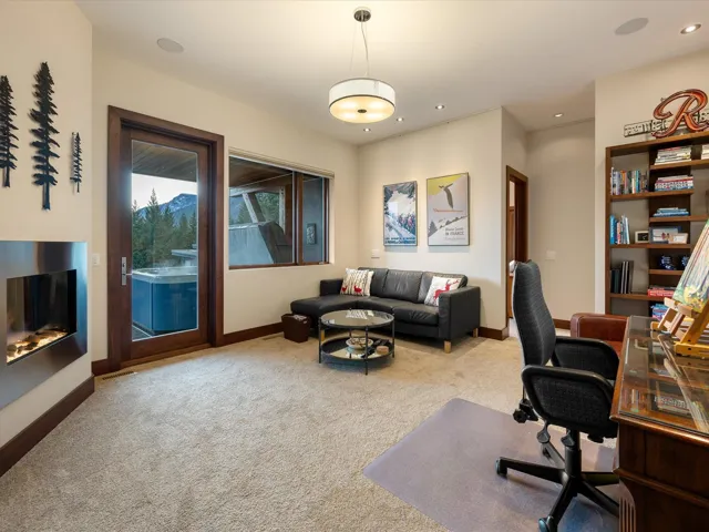 Office with light colored carpet and recessed lighting