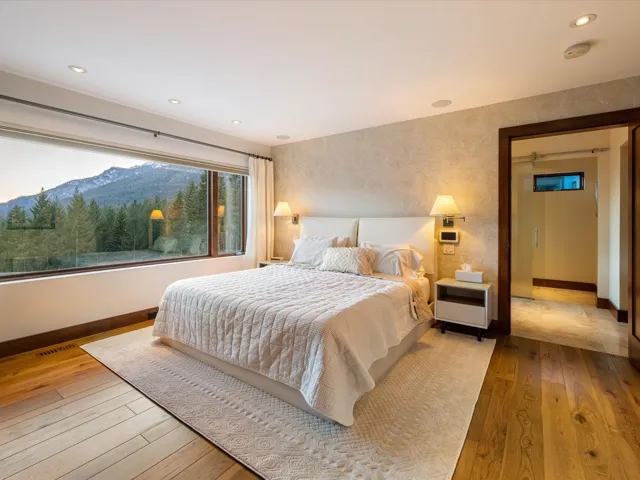 Bedroom with light wood-type flooring, a mountain view, wallpapered walls, and recessed lighting