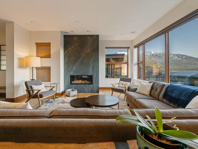 Living room featuring a high end fireplace, wood finished floors, a mountain view, and recessed lighting
